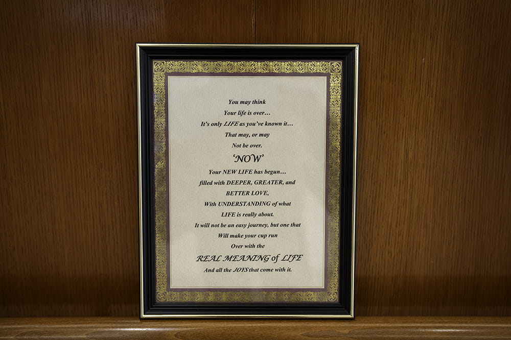 an image of a framed poem propped against the wall