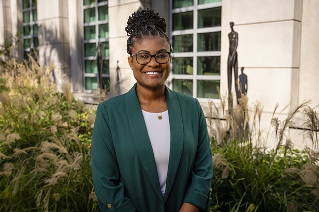 Dr. Trisha Amboree stands outside in a garden