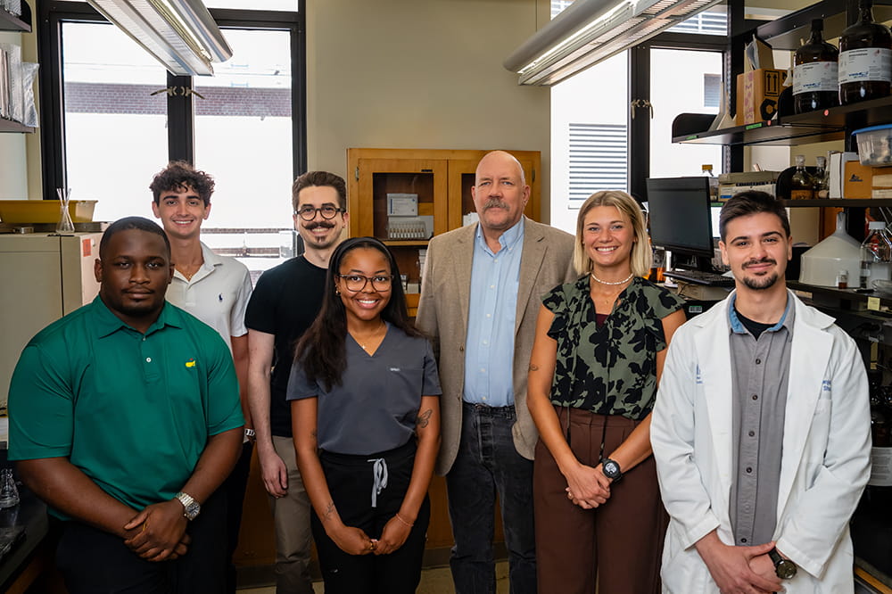 researchers pose in a scientific lab