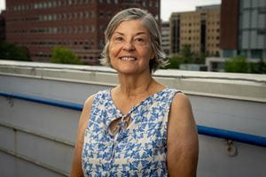 portrait of a woman on rooftop with MUSC buildings behind her