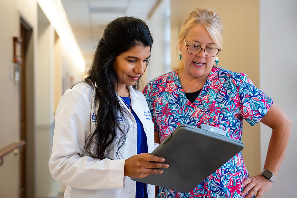 Abirami Sivapiragasam consults with nurse in hallway